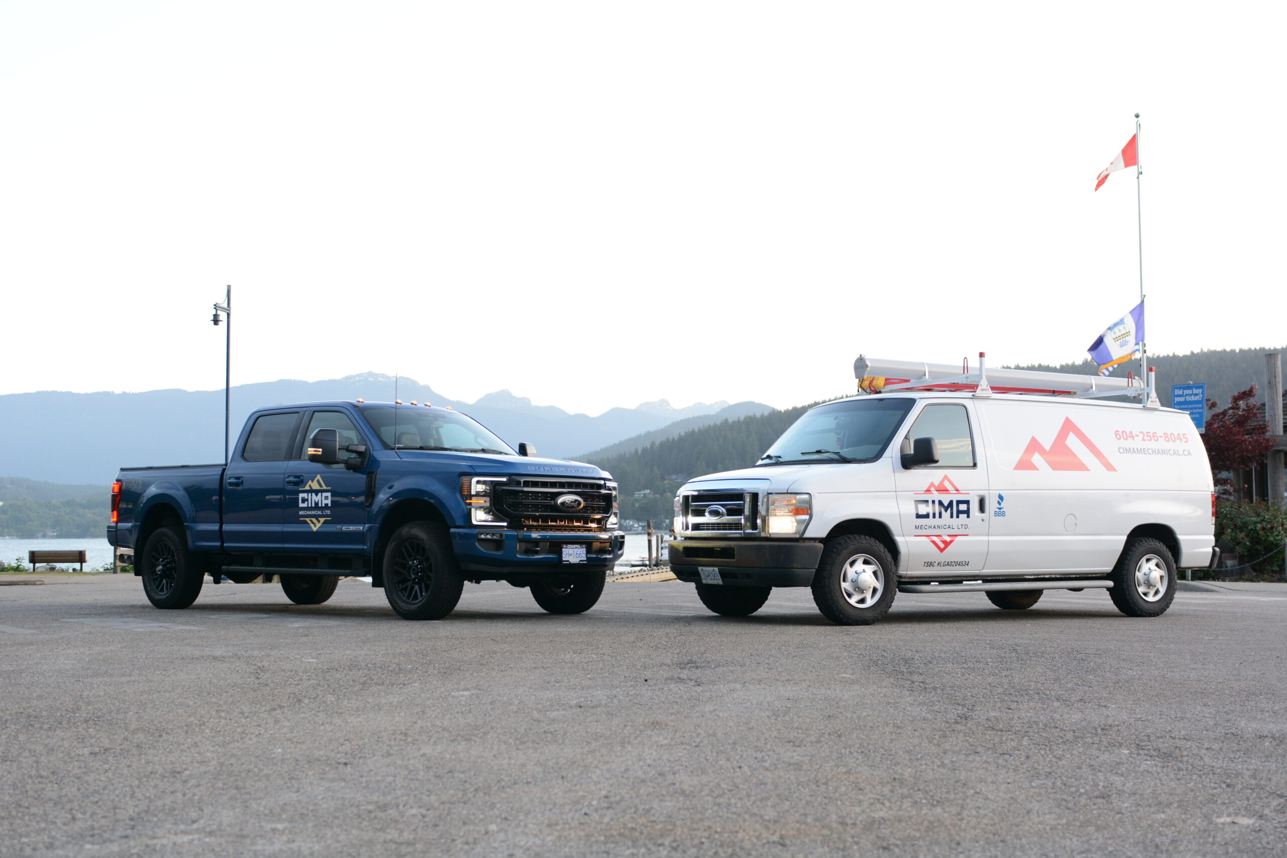 Cima fleet vehicles for a plumbing, heating and gas company with a backdrop of port moody in the background